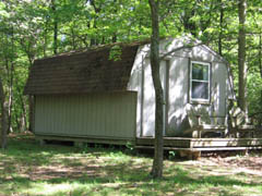The writer's cabin ohas an airconditiioner, heater, a double bed., and composting toilet.
